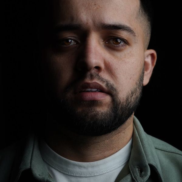 Silhouette of a man in a balanced pose against a dark background.